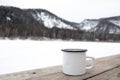 Cup with coffee on table over mountains landscape. Hiking and camping concept. Metal mug in the mountains Royalty Free Stock Photo