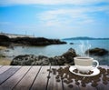 Cup with coffee on table over sea