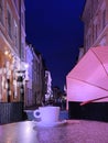 Cup of coffee on table pink top relaxation evening City Light blurred bokeh effect Street cafe tables restaurant Old Town Tall