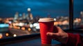 cup of coffee on window topin street cafe at night ,view on rainy city blurred light Royalty Free Stock Photo