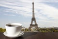 Cup of coffee on the table with view of Eiffel tower in Paris Royalty Free Stock Photo