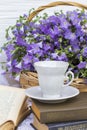 Cup coffee tea, books and bouquet flax in wicker Royalty Free Stock Photo