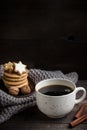 Cup of coffee/tea, christmas cookies with nuts and scarf on wooden table