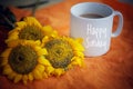 Cup Of Coffee Or Tea And Flowers Arrangement On Orange Background. With Text Greeting On White Mug - Happy Sunday.