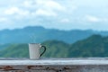 Cup coffee and tea with steam on wood table outdoor over mountains landscape with sunlight. Beauty nature background Royalty Free Stock Photo