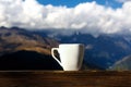 Cup coffee and tea with steam on wood table over mountains landscape. Royalty Free Stock Photo