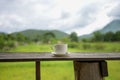 Cup of coffee or tea on a wooden table over mountains landscape and rice field with sunlight. Beauty nature background Royalty Free Stock Photo