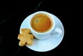 Cup of Coffee with Teddy Bear Shaped Cookie Isolated on Black Marble Table Royalty Free Stock Photo