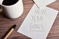 Cup of coffee and text new year goals Royalty Free Stock Photo