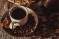Cup of coffee on textile with beans, dark candy sugar, pots, basket Royalty Free Stock Photo