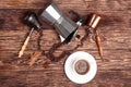 Cup of coffee, three coffeepots, cinnamon, anise, coffee beans on a wooden tray. View from the top