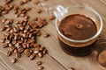 Cup of coffee on a tray and coffee beans on a wooden background