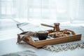 Cup with coffee, turk and cookie on wooden serving tray.