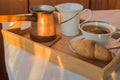 Cup of coffee, Turk, croissants on wooden plate closeup. Breakfast, Selective focus.