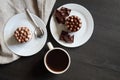 Cup of coffee and two chocolate cakes on a wooden table, top view Royalty Free Stock Photo