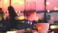 cup of coffee and two glass of wine people silhouette drink orange wine on beach cafe at romantic pink sunset evening on sea Royalty Free Stock Photo