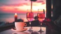 cup of coffee and two glass of wine people silhouette drink orange wine on beach cafe at romantic pink sunset evening on sea Royalty Free Stock Photo