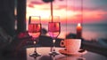 cup of coffee and two glass of wine people silhouette drink orange wine on beach cafe at romantic pink sunset evening on sea Royalty Free Stock Photo