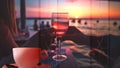 cup of coffee and two glass of wine people silhouette drink orange wine on beach cafe at romantic pink sunset evening on sea Royalty Free Stock Photo