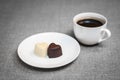 Cup of coffee and two heart-shaped chocolates Royalty Free Stock Photo