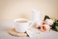 A cup of coffee, vintage toy heart, pink roses and jug with milk on a table. Valentines day concept. Morning breakfast Royalty Free Stock Photo