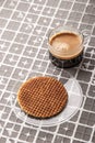 Cup of coffee with wafer on the relief background vertical Royalty Free Stock Photo