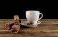 Cup of coffee and waffles on a wooden table isolated on a black Royalty Free Stock Photo