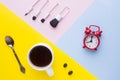 Cup of coffee, Watch the Clock and make-up brushes on colorful backgrounds. Concept business morning. Royalty Free Stock Photo