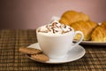 Cup of coffee with whipped cream and croissants Royalty Free Stock Photo