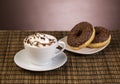 Cup of coffee with whipped cream and donut Royalty Free Stock Photo