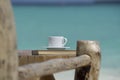 A cup of coffee in a white cup on beach sea background Royalty Free Stock Photo