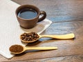 Cup of coffee on white napkin, grain of coffee and ground cof Royalty Free Stock Photo