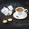 A cup of coffee, white orchid flowers, coffee beans and white candles. Romantic composition Royalty Free Stock Photo