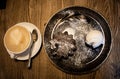 Cup of coffee on a white saucer with chocolate muffin and ice cream