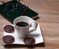 Cup with coffee on a white saucer.There are three chocolate chip cookies on the saucer. Royalty Free Stock Photo