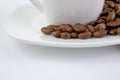 A cup of coffee on a white table. Coffee beans on a saucer close up Royalty Free Stock Photo