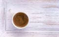 Cup of coffee on white wooden salver