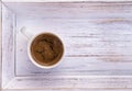 Cup of coffee on white wooden salver