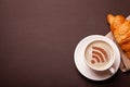Cup of coffee with WiFi sign on the foam. Free access point to the Internet WiFi. I like coffee break with croissant Royalty Free Stock Photo