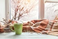 Cup of coffee on the window sill