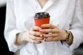 Cup of coffee in woman`s hand , break, energy and strength, hot drink in paper cup