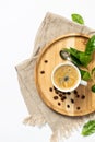 Cup of coffee on a wooden plate, flat lay