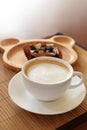 Cup of coffee on wooden table with confectioners atmosphere