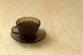 Cup of coffee on wooden table. dark glass cup of Herbal tea or coffee