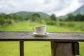Cup of coffee on a wooden table over mountains landscape and rice field with sunlight. Beauty nature background Royalty Free Stock Photo