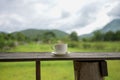 Cup of coffee on a wooden table over mountains landscape and rice field with sunlight. Beauty nature background Royalty Free Stock Photo