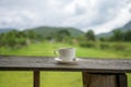 Cup of coffee on a wooden table over mountains landscape and rice field with sunlight. Beauty nature background Royalty Free Stock Photo