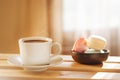 Cup of coffee on wooden table, window light, side view Royalty Free Stock Photo