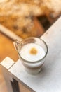 A cup of coffee on wooden table with work break time, food concept. Close up of a glass of hot Coffee Latte with nice milk form