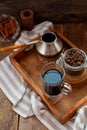 A cup of coffee on a wooden tray. Turk and coffee beans. Cook breakfast at home. Still life with a drink in a glass. Ground coffee